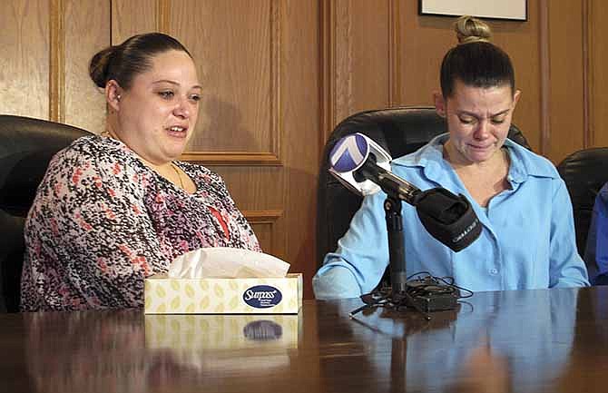 Amber McGuire, left, recounts the execution of her father, Dennis McGuire, as her sister-in-law Missie McGuire cries at a news conference Friday, Jan. 17, 2014, in Dayton, Ohio, where they announced a planned lawsuit against the state over the unusually slow execution. McGuire's lawyers had attempted last week to block his execution, arguing that the untried method could lead to a medical phenomenon known as "air hunger" and could cause him to suffer "agony and terror" while struggling to catch his breath. 