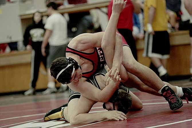
Jefferson City wrestler Ian Coil takes down Lebanon's Jared Schmitt during their 195-pound match Saturday morning in the Capital City Invitational at Fleming Fieldhouse.