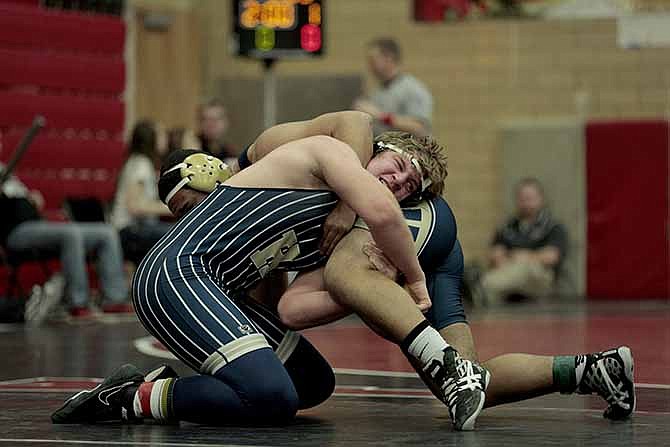 Helias 220-pounder Ben Davis resists a take down from Wentzville-Holt wrestler Devon Byrd Saturday morning at the Capital City Invitational at Fleming Fieldhouse.