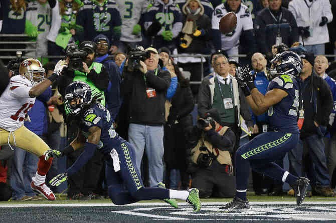 Seattle Seahawks' Malcolm Smith intercepts a pass in the final seconds of the second half of the NFL football NFC Championship game against the San Francisco 49ers, Sunday, Jan. 19, 2014, in Seattle. The Seahawks won 23-17 to advance to Super Bowl XLVIII. 