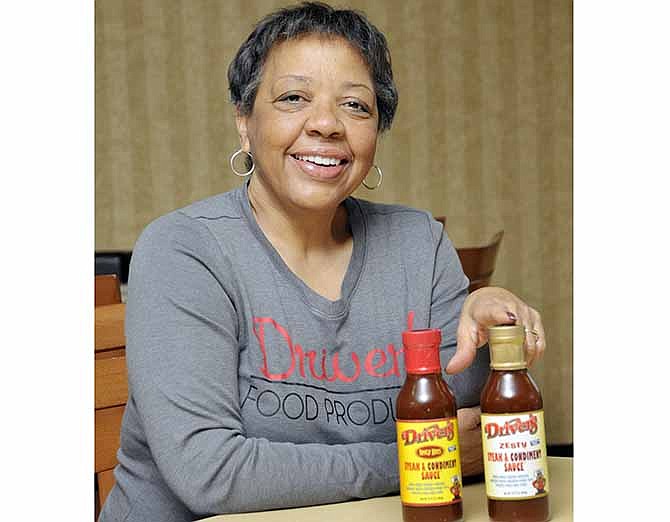 Annette Driver poses with her new product, Driver's Steak and Condiment Sauce.