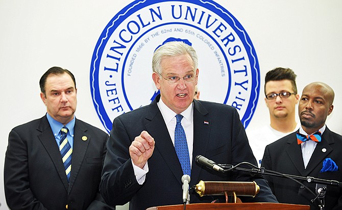 Sen. Mike Kehoe, left, and LU President Kevin Rome, right, listen as Gov. Jay Nixon announces a $10 million deal that turns St. Mary's Health Center over to the sate of Missouri and alllows Lincoln University for expansion of its nursing school program. 