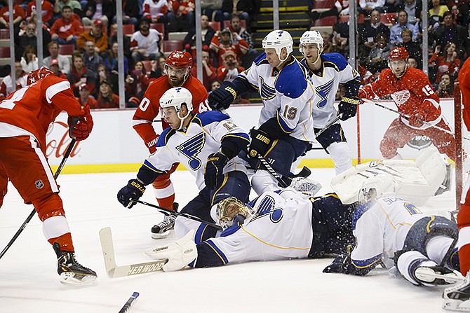 Red Wings center Gustav Nyquist (left) scores a goal on Blues goalie Jaroslav Halak as he is flat on the ice in the first period at Joe Louis Arena.