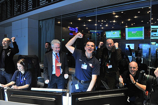 Technicians celebrate Monday after receiving the Rosetta wake up signal in the control room of the European Space Agency in Darmstadt, Germany. Waking up after almost three years of hibernation, a comet-chasing spacecraft sent its first signal back to Earth.