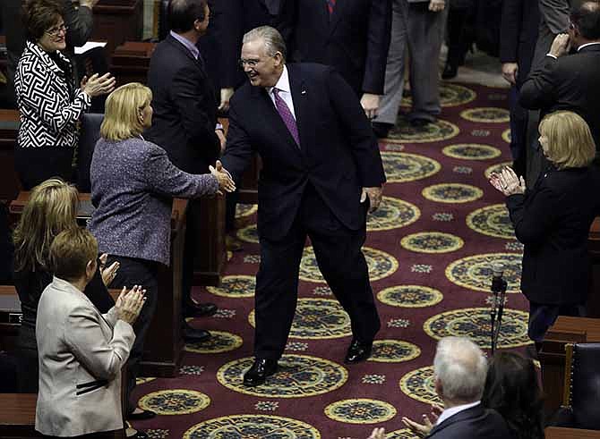 Missouri Gov. Jay Nixon greets lawmakers as he walks into the House chamber to deliver the annual State of the State address to a joint session of the House and Senate Tuesday, Jan. 21, 2014, in Jefferson City, Mo. 