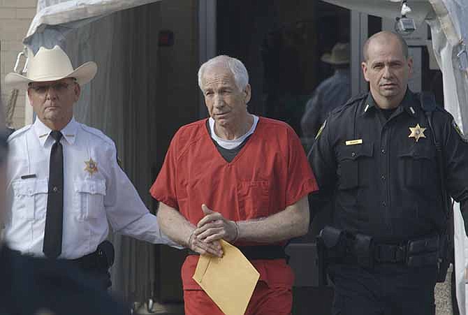 This photo provided by the Sundance Institute shows Jerry Sandusky, center, in the documentary film, "Happy Valley," by director Amir Bar-Lev. The Sundance Film Festival runs Jan. 16-26, 2014, in Park City, Utah.