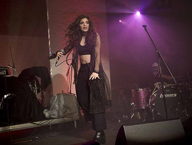 In this Oct. 31, 2013 file photo, New Zealand singer-songwriter Lorde performs on stage during the Vevo Halloween Concert at the Oval Space in east London. Lorde has four nominations at the Grammy Awards on Sunday, Jan. 26, 2014, including song and record of the year for "Royals." 