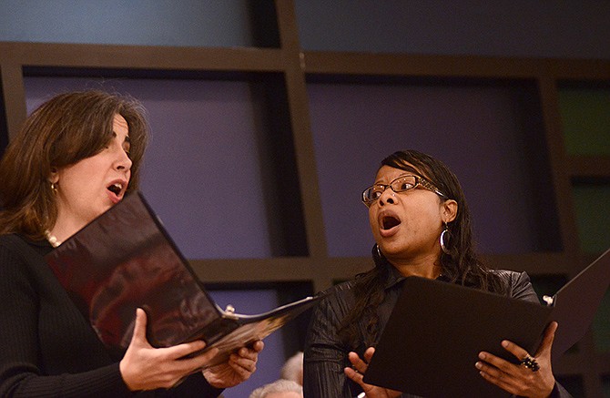 Natasia Sexton, left, and Maggie George perform "We Are Climbing Jacob's Ladder" during the Faith Voices for Jefferson City founding convention on Thursday at Quinn Chapel AME Church.
