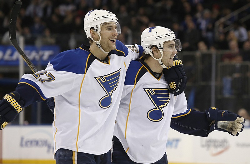 Blues defensemen Alex Pietrangelo (left) and Kevin Shattenkirk celebrate after Shattenkirk scored a goal in the third period of Thursday night's game against the Rangers in New York.