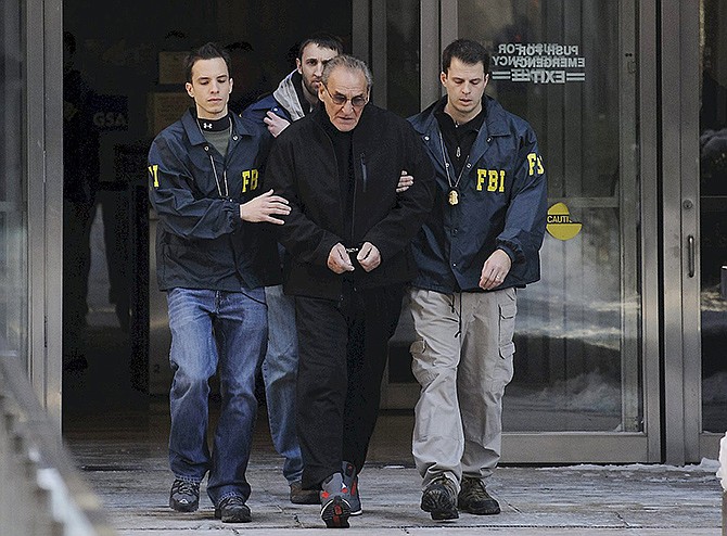 FBI agents flank Vincent Asaro as they escort the reputed mobster from FBI offices in lower Manhattan on Thursday in New York. More than 30 years after the crime, Asaro was indicted in the $6 million Lufthansa heist at Kennedy Airport that was dramatized in the Martin Scorsese movie "Goodfellas."