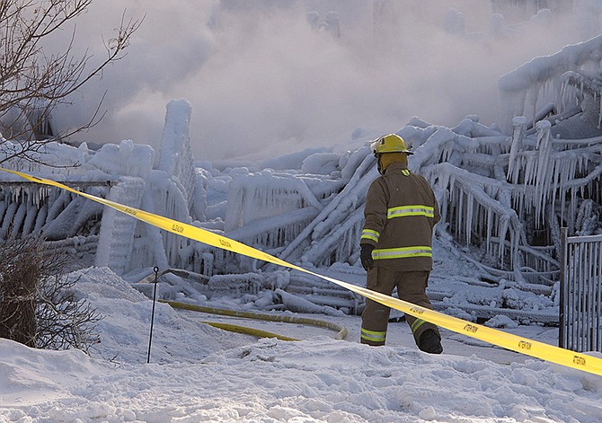 Firefighters work at the scene of a senior's residence fire on Thursday, in L'Isle-Verte, Quebec. The fire raged through the seniors' residence, killing at least three people and leaving about 30 unaccounted for. The massive fire in the 52-unit complex broke out around 12:30 a.m. in L'Isle-Verte, about 140 miles northeast of Quebec City.