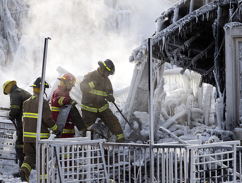 Using steam to melt the ice, investigators searched the frozen-over ruins of a retirement home Friday for victims of a fire that left at least eight people dead and about 30 missing.