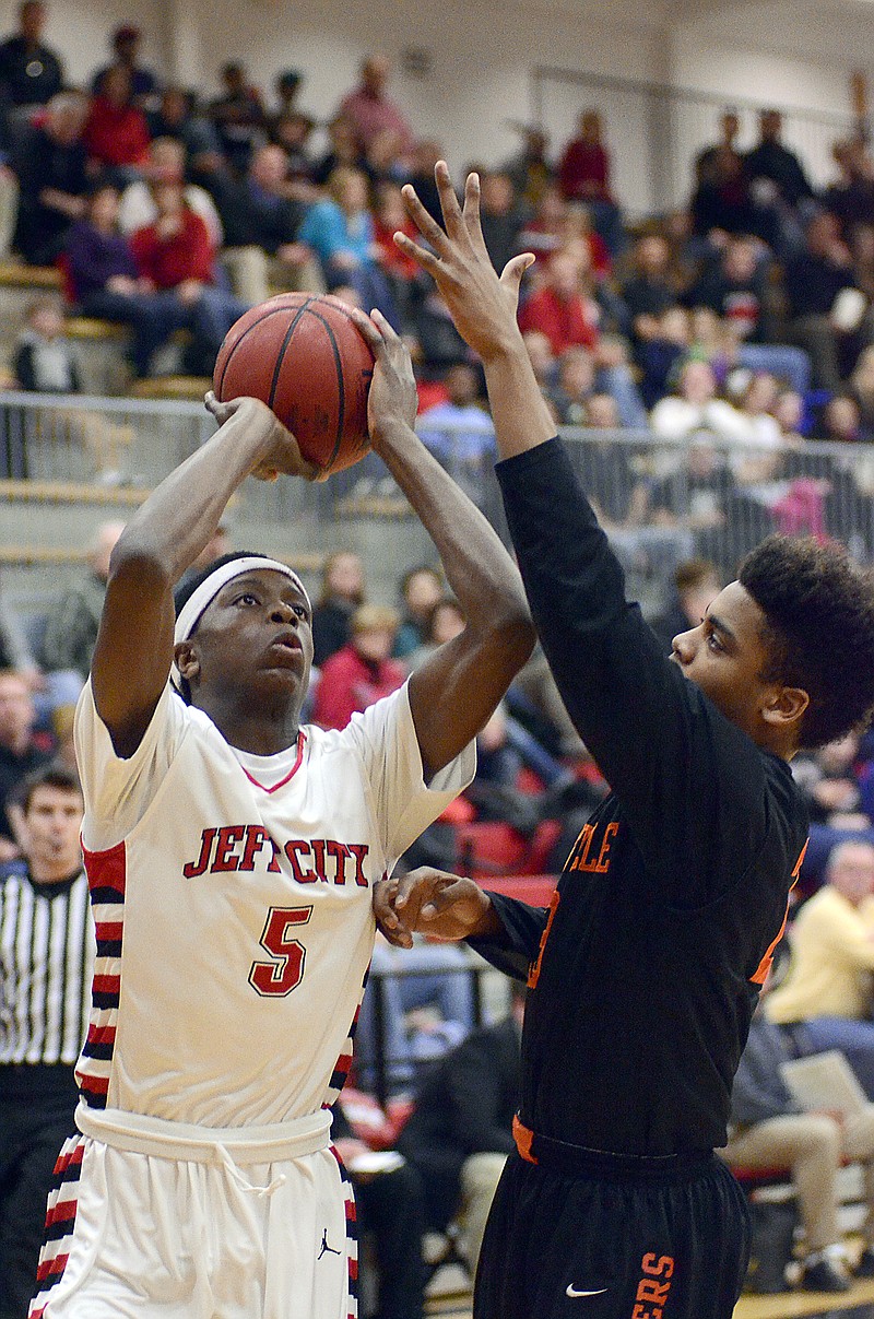 Jefferson City's O.G. Anunoby looks to take a shot over Waynesville's Juwan Morgan during Friday's game at Fleming Fieldhouse.