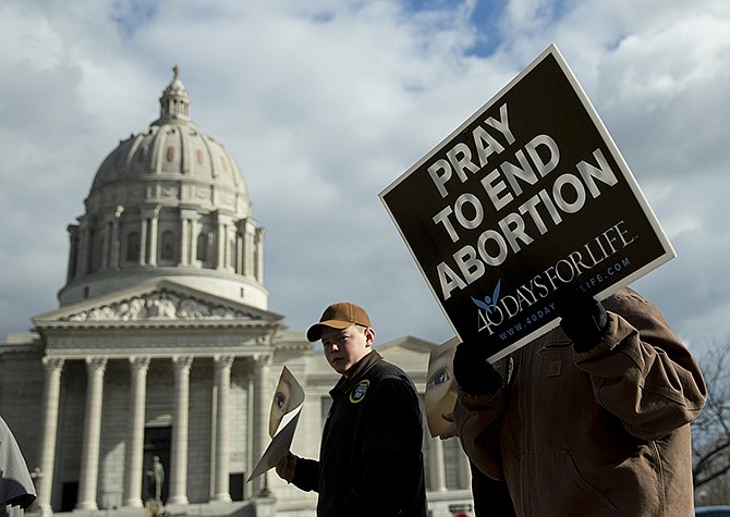 A participant in the March for Life holds a sign reading "Pray to end abortion" Saturday morning as protesters marched in front of the Capitol on their way to the South Lawn for a pro-life rally.