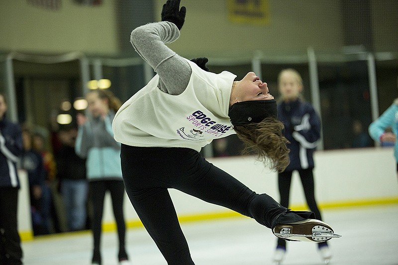 Sasha Cohen gives tips to young skaters on performing some of her signature moves Saturday afternoon at Washington Park Ice Arena.