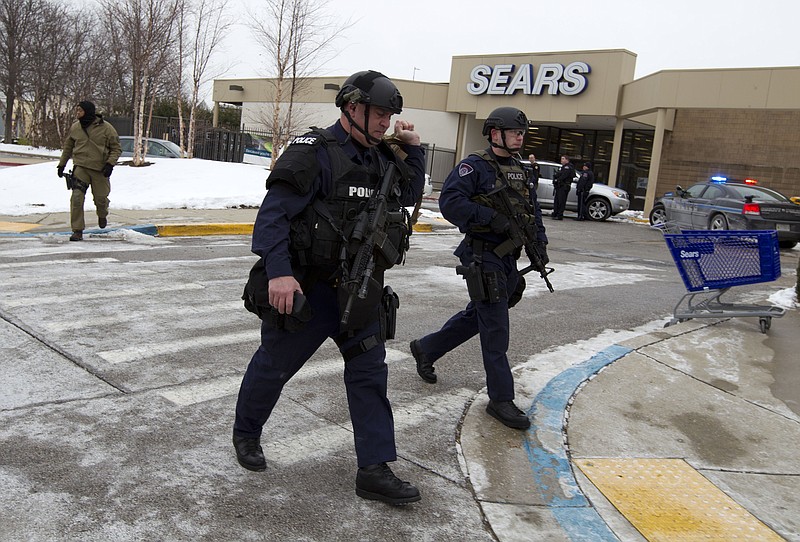 Police move in from a parking lot to the Mall in Columbia after reports of a multiple shooting Saturday in Howard County, Md.  Police in Maryland say three people died Saturday in a shooting at a mall in suburban Baltimore, including the presumed gunman. 