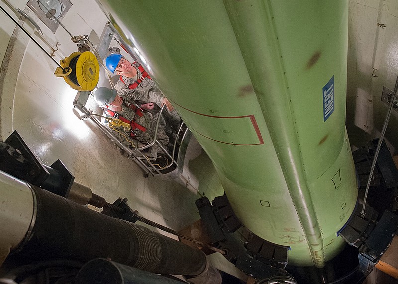 This image provided by the U.S. Air Force shows Air Force Chief of Staff Gen. Mark Welsh, right, and Tech. Sgt. Justin Richie, a 341st Maintenance Operations Squadron team trainer, riding in a work cage on Nov. 20, 2012, inside the T-9 maintenance trainer at Malmstrom Air Force Base, Mont.