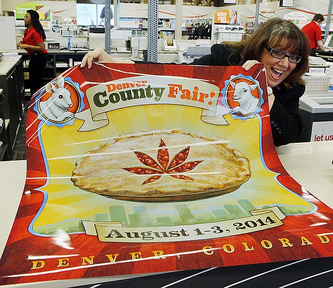 Dana Cain, director of the Denver County Fair, shows a poster advertising the fair at a print shop. Colorado's Denver County is adding cannabis-themed contest to its 2014 summer fair.