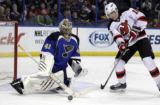 St. Louis Blues goalie Jaroslav Halak (41) makes a stick save on a point blank shot from New Jersey Devils' Steve Bernier (18) in the first period of an NHL hockey game, Tuesday, Jan. 28, 2014 in St. Louis. 