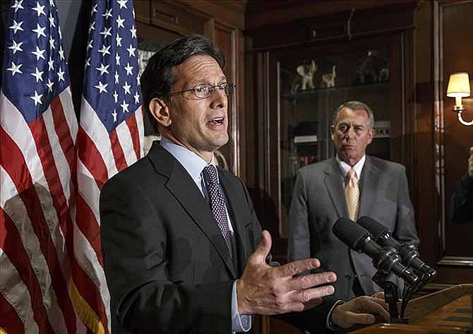 On the day of President Barack Obama's State of the Union address, House Majority Leader Eric Cantor of Va., left, with House Speaker John Boehner of Ohio, talks with reporters after a GOP strategy session, Tuesday, Jan. 28, 2014, at Republican National Committee headquarters in Washington.