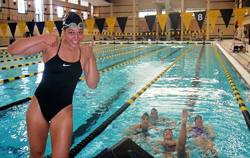 In this photo provided by Mike Menu is his daughter, Sasha Menu Courey, with teammates. The Canadian family of former University of Missouri school swimmer says the school and its athletics department failed to properly investigate her alleged off-campus rape by as many as three football players in 2010. Menu Courey struggled with mental illness and committed suicide 16 months later.