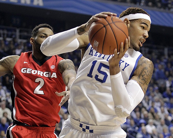 Kentucky's Willie Cauley-Stein pulls down a rebound next to Georgia's Marcus Thornton during the first half of Saturday's game in Lexington, Ky.
