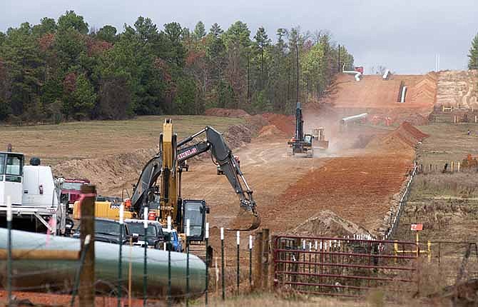 In this Dec. 3, 2012 file photo, crews work on construction of the TransCanada Keystone XL Pipeline near County Road 363 and County Road 357, east of Winona, Texas. In a move that disappointed environmental groups and cheered the oil industry, the Obama administration on Jan. 31, 2014, said it had no major environmental objections to the proposed Keystone XL oil pipeline from Canada.