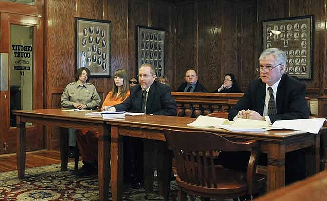 Cole County Prosecuting Attorney Mark Richardson, right, listens as attorney, Gary Brotherton, and his client, Alyssa Bustamante look on in Cole County Circuit Court in Jefferson City, Mo., Thursday, Jan. 30, 2014. Bustamante appeared for a hearing on whether to set aside her plea in the 2009 slaying of 9-year-old Elizabeth Olten. Bustamante was 15 at the time. She initially faced a first-degree murder charge, punishable by a mandatory life sentence without parole. Bustamante pleaded guilty in 2012 to second-degree murder. She was sentenced to life with the chance of parole.