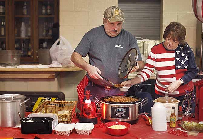 Chris Debroeck and his wife, Angie Debroeck, prepare chili samples Saturday morning for the public during the Navy Ship Club's Annual Chili Cook-Off at the American Legion in Jefferson City. The event was a fundraiser with the goal of sending at least one child with cancer to Camp Quality. The Debroecks' chili won first place in the individual category.