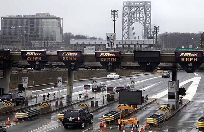 This Jan. 11, 2014, file photo shows traffic passing through the toll booths at the George Washington Bridge, in Fort Lee, N.J. Gov. Chris Christie made inaccurate statements during a news conference about the lane closures near the George Washington Bridge, according to a letter released Friday, Jan. 31, 2014, by a lawyer for a former Christie loyalist who ordered the closures and resigned amid the ensuing scandal that has engulfed the New Jersey governor's administration. In the letter, David Wildstein's lawyer said his client "contests the accuracy of various statements that the governor made about him and he can prove the inaccuracy of some."