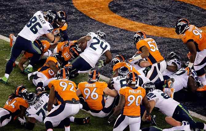 Seattle Seahawks' Marshawn Lynch (24) rushes for a touchdown during the first half of the NFL Super Bowl XLVIII football game against the Denver Broncos Sunday, Feb. 2, 2014, in East Rutherford, N.J. 