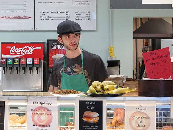 In this Monday, Jan. 27, 2014 photo, Neal Breen, 21, works at the Ashburn Bagel & Sandwich Shop in Ashburn, Va. 