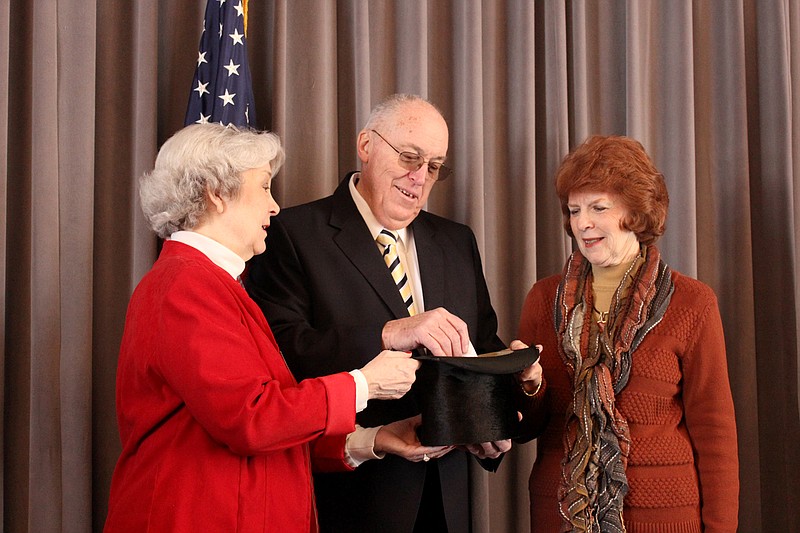 Flanked by Kingdom of Callaway Historical Society representatives Diane Burre Ludwig and Barbara Huddleston, Fulton Mayor LeRoy Benton draws a president's name from a hat to determine who will be the topic of a category of questions in the Historical Society's inaugural President's Day Trivia. Benton drew Jimmy Carter, America's 39th president.