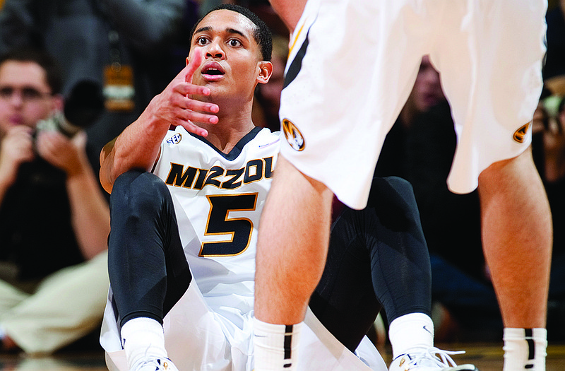 Missouri's Jordan Clarkson is helped up off the court by a teammate as he looks at the referee in disbelief after he thought he was fouled during Saturday's game against Kentucky at Mizzou Arena.