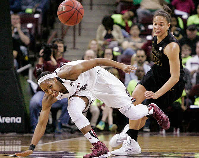 South Carolina's Tiffany Mitchell (25) looses control of the ball as she is fouled by Missouri's Bri Kulas (13) during the first half of their NCAA college basketball game Sunday Feb. 2, 2014, in Columbia, SC. 