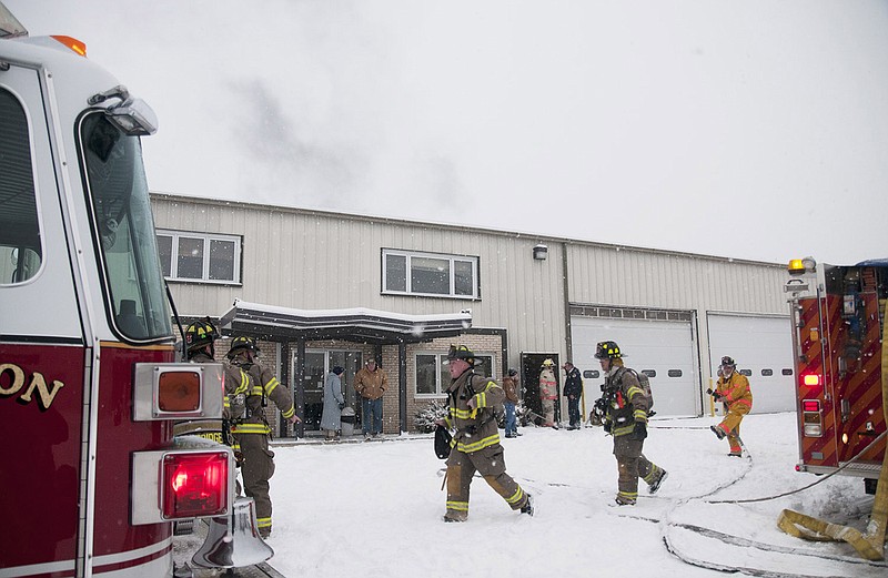 Firefighters from the Fulton Fire Department work to put out a fire inside the Backer's Potato Chip plant Tuesday. 