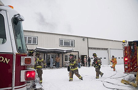 Firefighters from the Fulton Fire Department work to put out a fire inside the Backer's Potato Chip plant Tuesday.