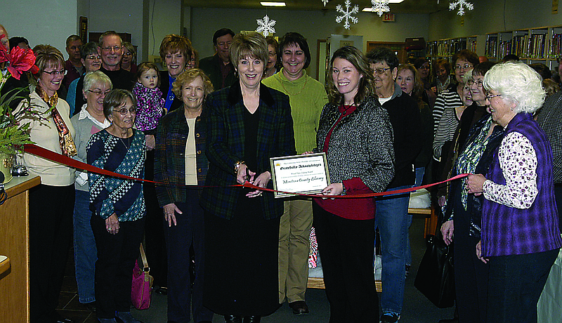 Connie Walker, formerly Wood Place Librarian and now Moniteau County Librarian, cuts the California Area Chamber of Commerce Ribbon acknowledging the establishment of a county library Thursday, Jan. 30. Chamber President Becky Lawson is to the left of Walker and Barbara Reader of the Missouri State Library is to the right. 