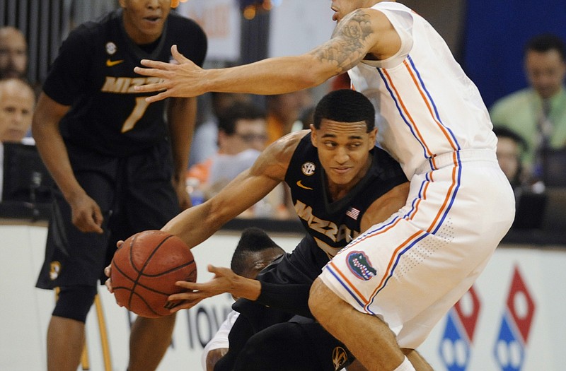 Jordan Clarkson of Missouri tries to get past Florida's Scottie Wilbekin during Tuesday night's game in Gainesville, Fla