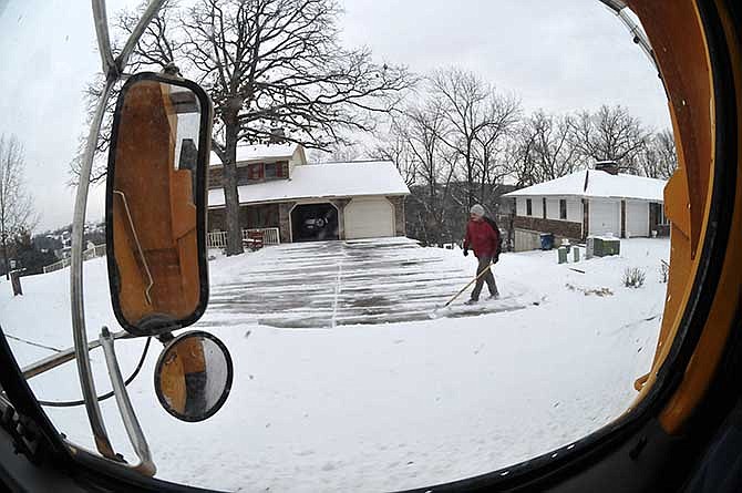 ABOVE: The disadvantage to a large driveway is that you have a large area to shovel when the snow falls. This Southwood Hills Subdivision resident got in a workout as he neared the end of the drive. 
