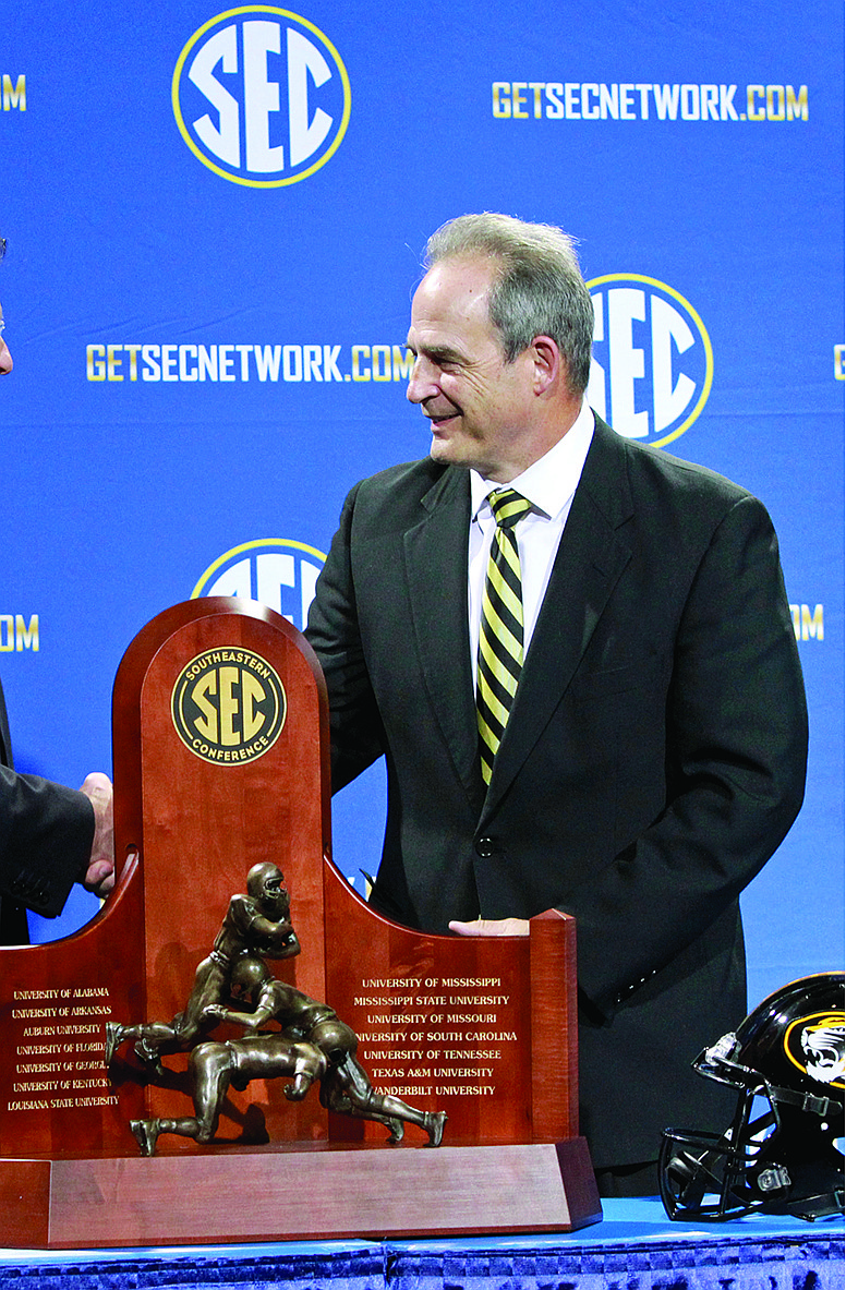 MIssouri head coach Gary Pinkel stands next to the SEC Championship trophy last December in Atlanta.