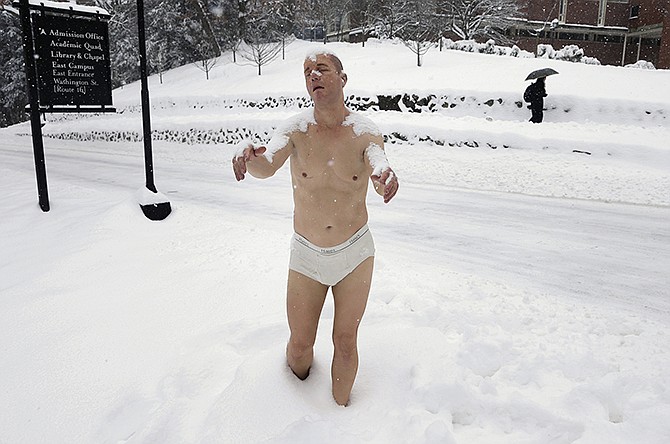 A statue of a man sleepwalking in his underpants is surrounded by snow on the campus of Wellesley College, in Wellesley, Mass. The sculpture entitled "Sleepwalker" is part of an exhibit by sculptor Tony Matelli at the college's Davis Museum. It is causing a stir as some students say the sculpture makes them feel uncomfortable.