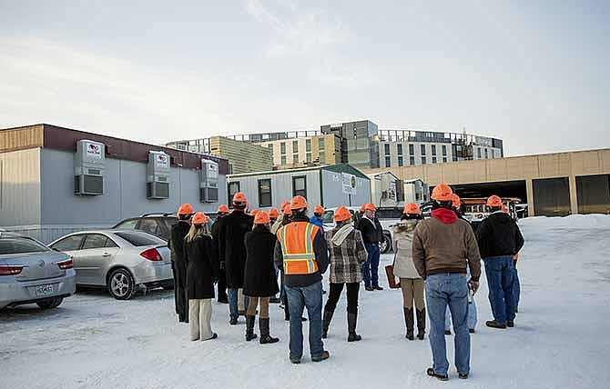 Community members listen to Project Manager Tim Gunn summarize recent progress before heading inside the new St. Mary's Health Center for a tour of construction that has been completed this winter. 