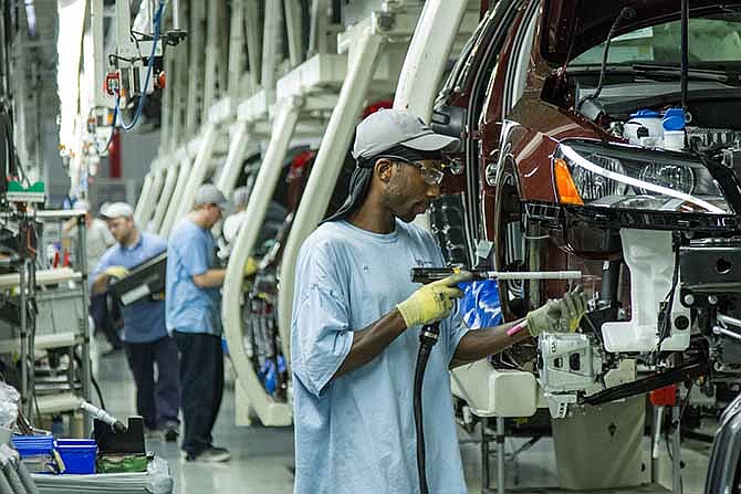 In this June 12, 2013, file photo, workers assemble Volkswagen Passat sedans at the German automaker's plant in Chattanooga, Tenn. Workers at Volkswagen's only U.S. factory will decide in February 2014 whether to be represented by the United Auto Workers union.