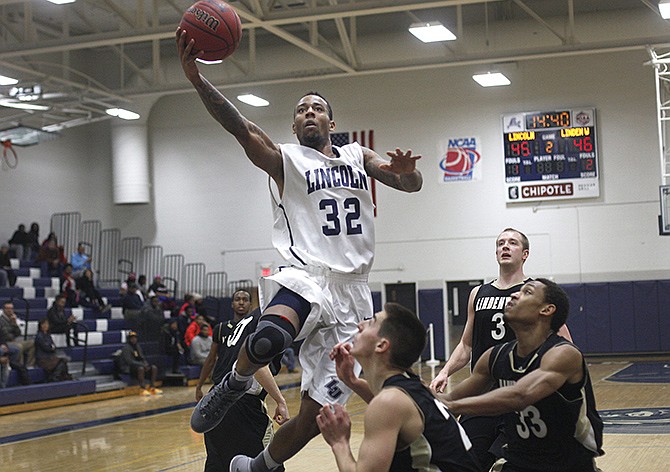 Lincoln junior Mike Smith flies above Lindenwood defenders toward the basket Thursday night at Jason Gym.