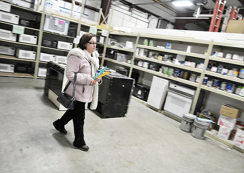 In this February 2014 photo, Gennifer Monteer looks over the appliances currently for sale at the Habitat for Humanity Restore in Jefferson City. (News Tribune photo)