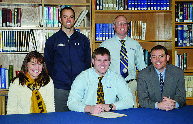 With coaches and his parents by his side, Will Fife signed a scholarship in the Helias High School library Friday morning. Seated are Brenda, Will and Matt Fife. Standing are coaches Chip Malmstrom and Mark Ordway.