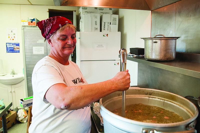 Connie Cashion of Holts Summit stirs a pot of boiling green beans on Dec. 1  at the Fulton Soup Kitchen for the kitchen's annual Thanksgiving dinner. The freezer that stored turkey meat for the dinner recently broke, but area businesses came together to purchase a new one.