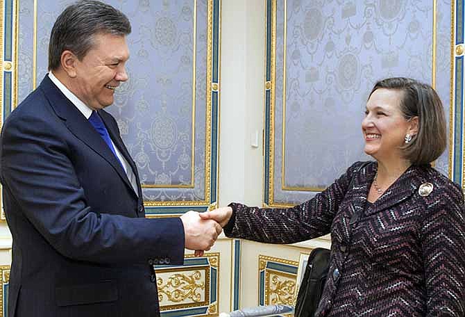 Ukraine's President Viktor Yanukovych, left, greets U.S. Assistant Secretary for European and Eurasian Affairs Victoria Nuland, in Kiev, Ukraine, Thursday, Feb. 6, 2014. Nuland and the U.S. ambassador to Ukraine, Geoffrey Pyatt, thinking their conversation about the Ukraine was secure and private, were caught disparaging the European Union in a phone call that was apparently bugged, and U.S. officials say they strongly suspect Russia of leaking the conversation.