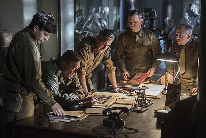 This image released by Columbia Pictures shows Dimitri Leonidas, John Goodman, George Clooney, Matt Damon and Bob Balaban in "The Monuments Men." 